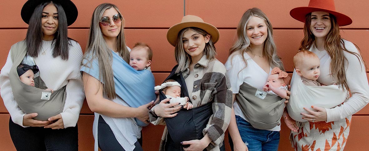 new native baby carrier shown in black, khaki, sky blue, and natural. organic cotton sling style carrier